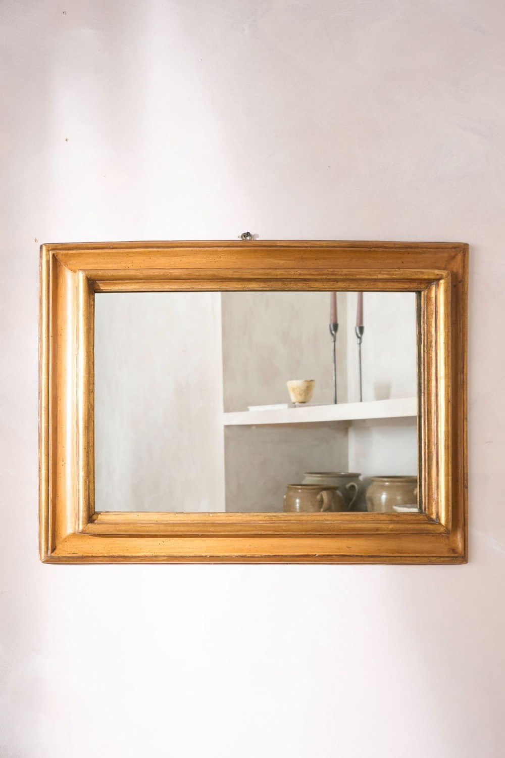 An 18th-century rectangular Italian wall mirror featuring a moulded gilded wooden frame.