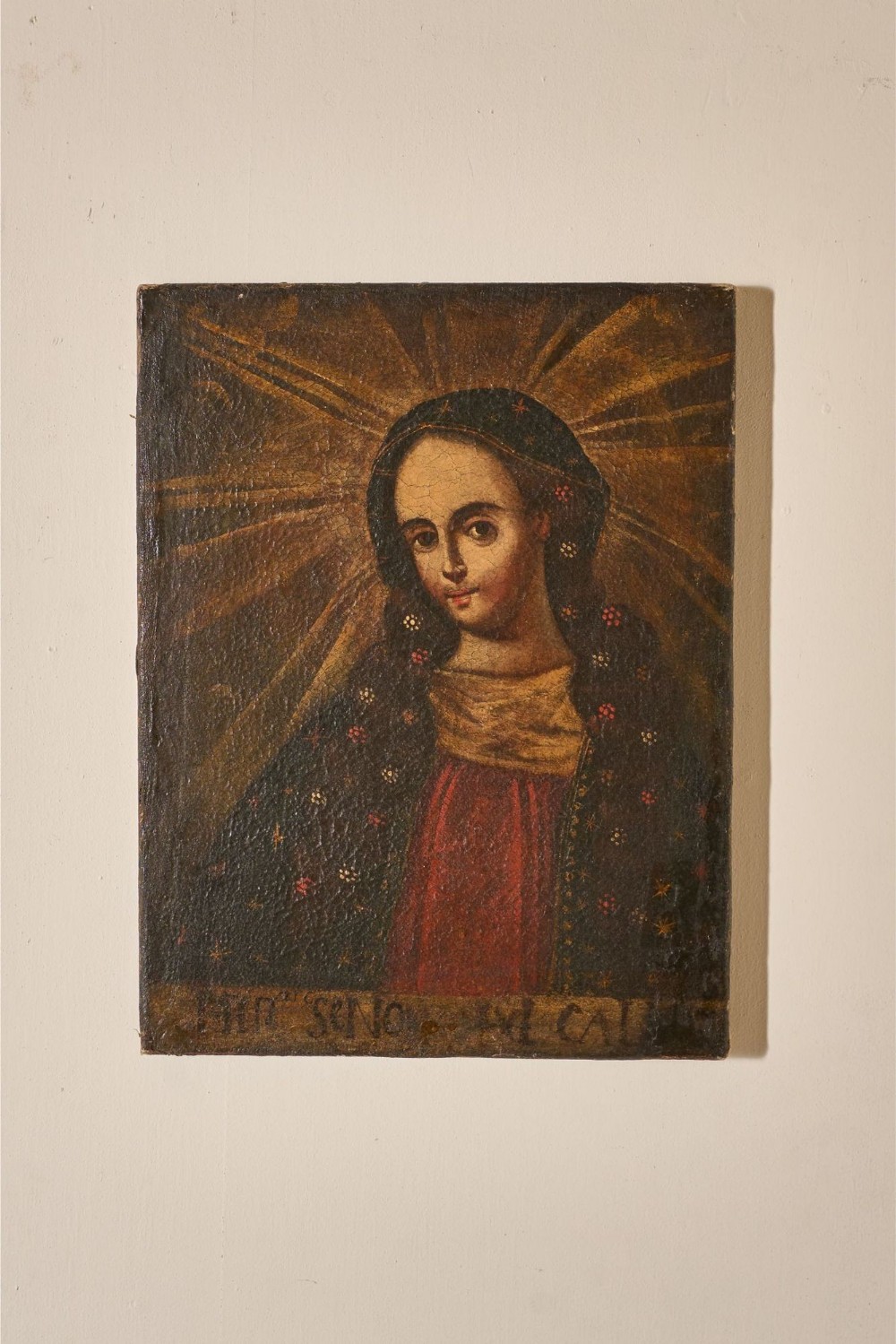 A 17th-century oil painting on canvas depicting the Virgin Mary with a halo of radiating light beams and a floral pattern mantle.