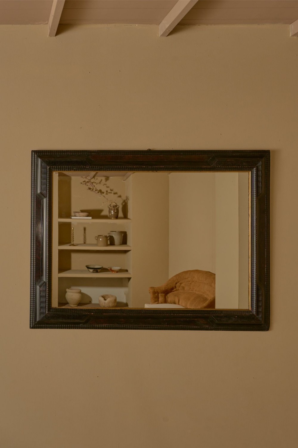 A large rectangular 19th-century Italian wall mirror featuring a dark ebonised timber frame with geometric mouldings and a thin gilt inner border.