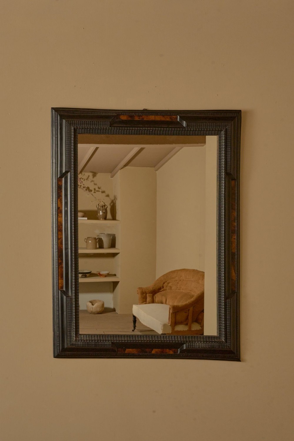 A large rectangular 19th-century Italian wall mirror framed in dark ebonised wood with inset faux tortoiseshell panels.