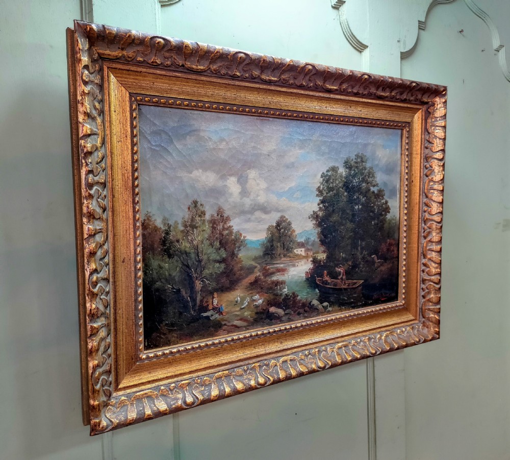 An 1890 Victorian landscape oil painting on canvas depicting figures in a rowboat along a river, housed in a carved gilded frame. View VI