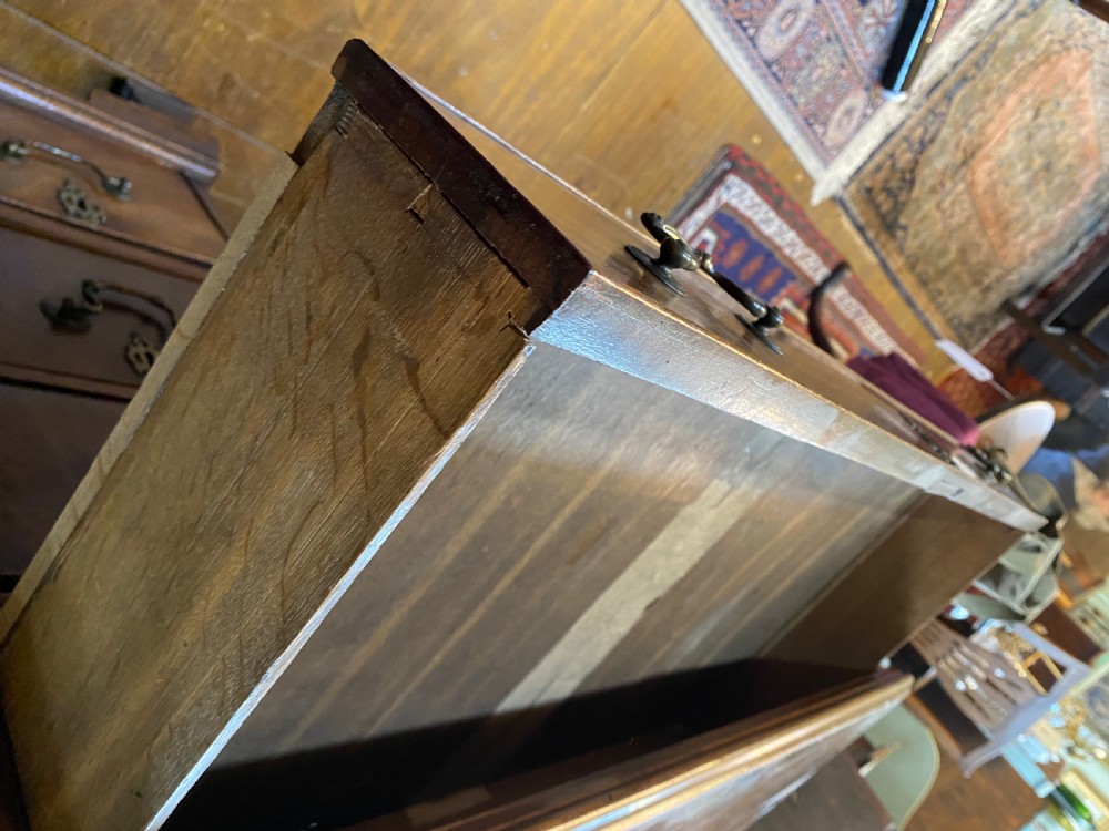 An eighteenth century Georgian mahogany kneehole desk featuring multiple drawers with brass handles, a central recessed cupboard, and bracket feet. View III