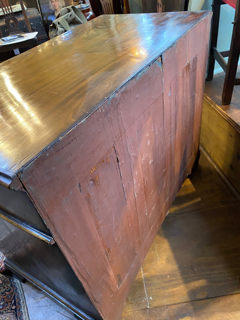 An eighteenth century Georgian mahogany kneehole desk featuring multiple drawers with brass handles, a central recessed cupboard, and bracket feet. View VI