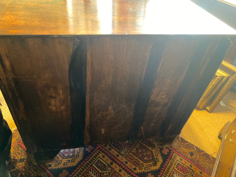 Mid 18th-century walnut kneehole secretaire desk featuring crossbanded drawer fronts, brass drop handles, a central recessed cupboard, and bracket feet. View IV