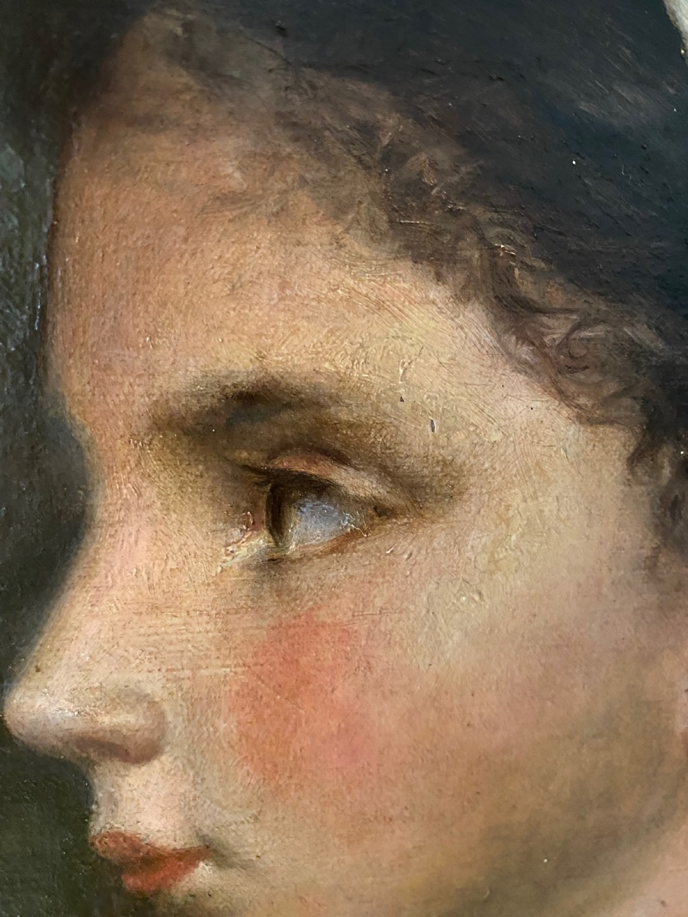 A 19th-century oil portrait depicting the side profile of a young girl wearing a white headscarf, pink shawl, and gold necklace, set within a moulded gilt frame. View III