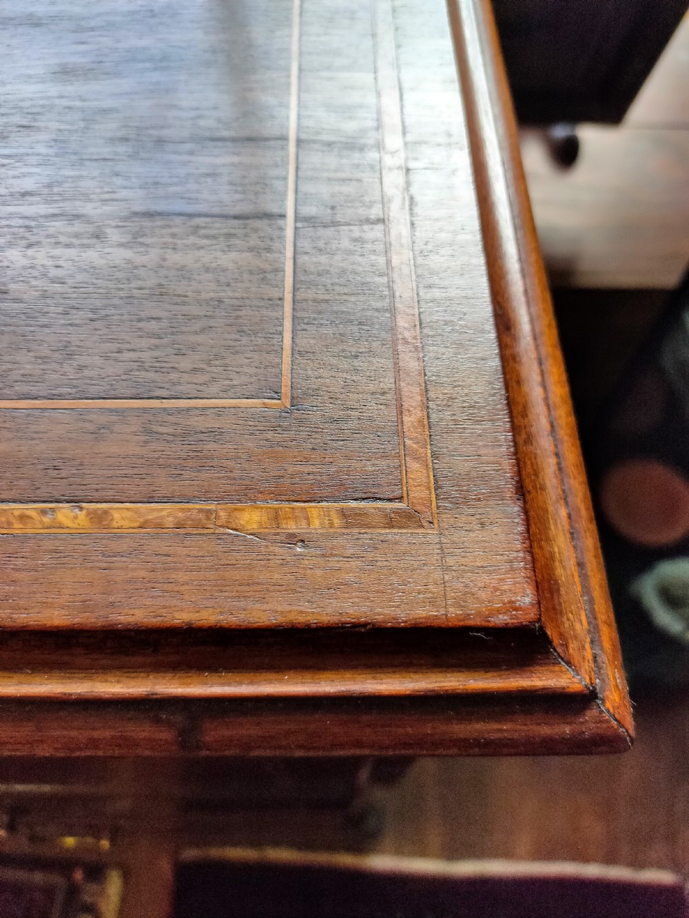 A late eighteenth-century mahogany chest of three drawers featuring fine boxwood stringing inlay, brass swan-neck handles, keyhole escutcheons, and bracket feet. View III