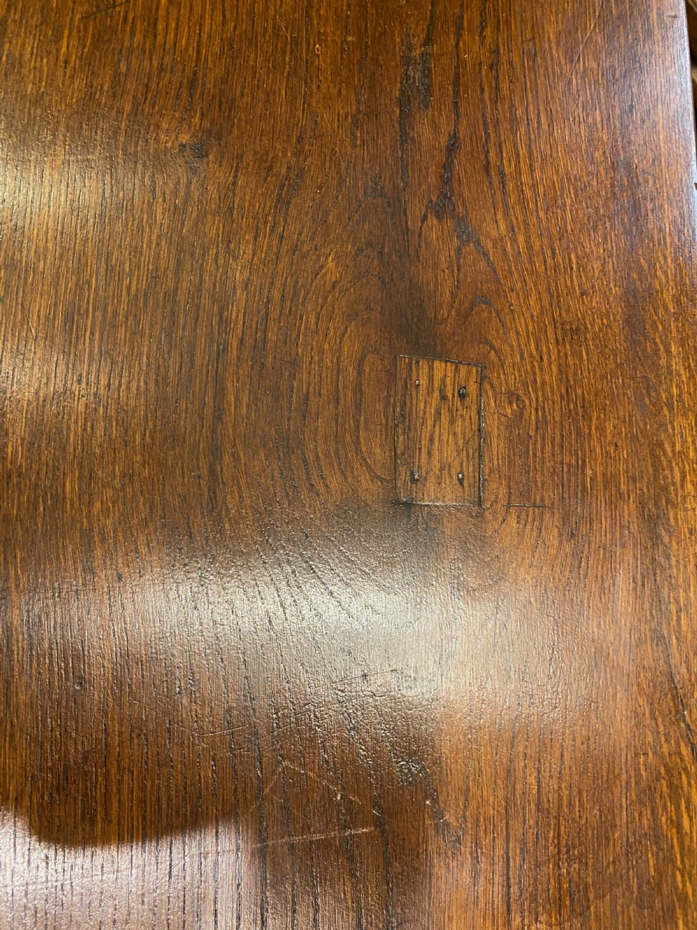 An early nineteenth-century solid oak refectory table featuring a two-plank top supported by shaped trestle end supports and a central stretcher. View IV
