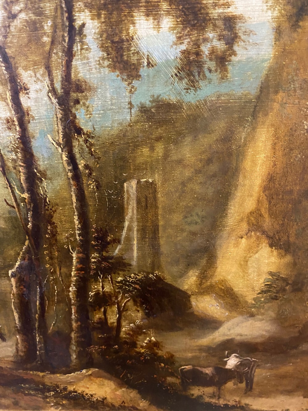 An eighteenth-century Dutch style oil painting on canvas depicting travellers and livestock on a path in a wooded landscape, housed in a golden moulded frame. View IV