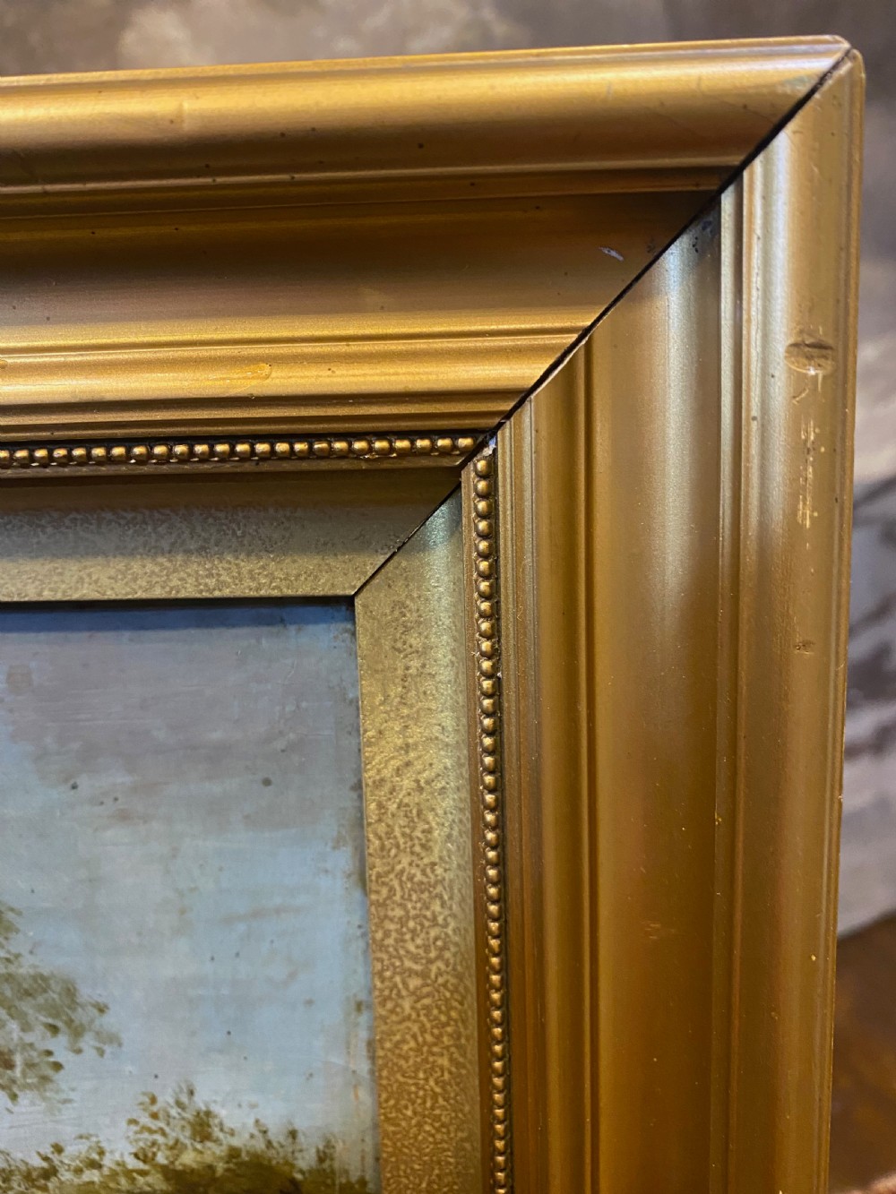 An eighteenth-century Dutch style oil painting on canvas depicting travellers and livestock on a path in a wooded landscape, housed in a golden moulded frame. View V