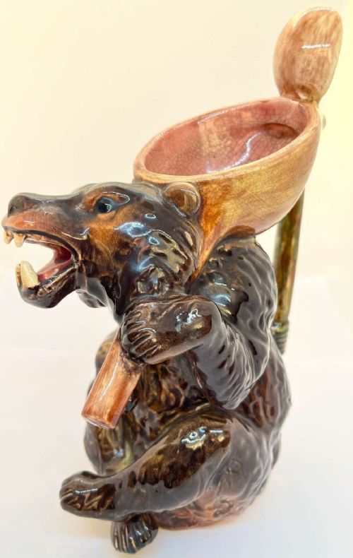 A Victorian earthenware majolica jug moulded in the form of a seated brown bear with an open snarling mouth and a pink-glazed interior. View II