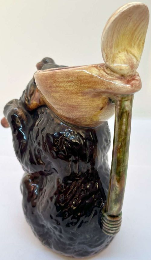 A Victorian earthenware majolica jug moulded in the form of a seated brown bear with an open snarling mouth and a pink-glazed interior. View IV