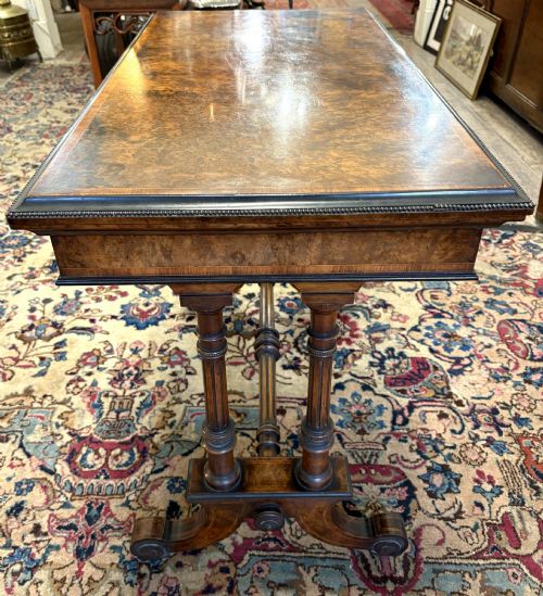 fig 1. A Victorian burr walnut card table featuring ebonised bead moulding, crossbanded veneer top, twin turned pillar supports, and a turned stretcher base.