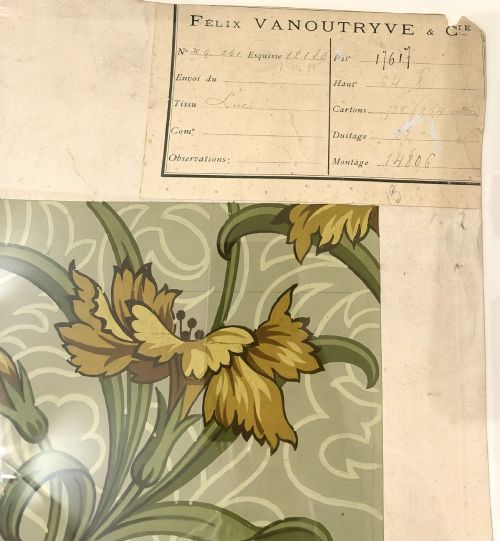 fig 2. A framed Art Nouveau textile design on gridded paper featuring yellow floral motifs and green foliage against a sage background with colour swatches and technical annotations.