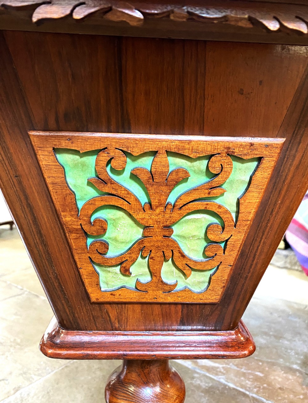 A Victorian walnut sewing table featuring a hinged lid decorated with an oval floral marquetry inlay set upon a carved tripod pedestal base. View III