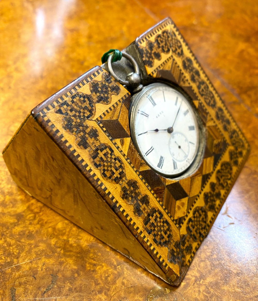A square Victorian Tunbridge ware wooden pocket watch stand featuring geometric mosaic parquetry around a central pocket watch. View III