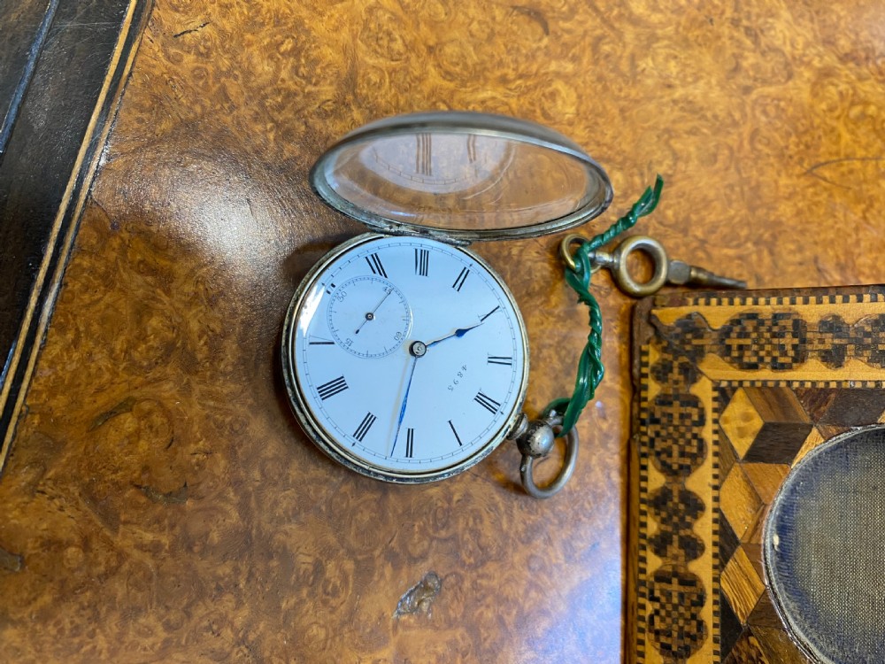 A square Victorian Tunbridge ware wooden pocket watch stand featuring geometric mosaic parquetry around a central pocket watch. View VII