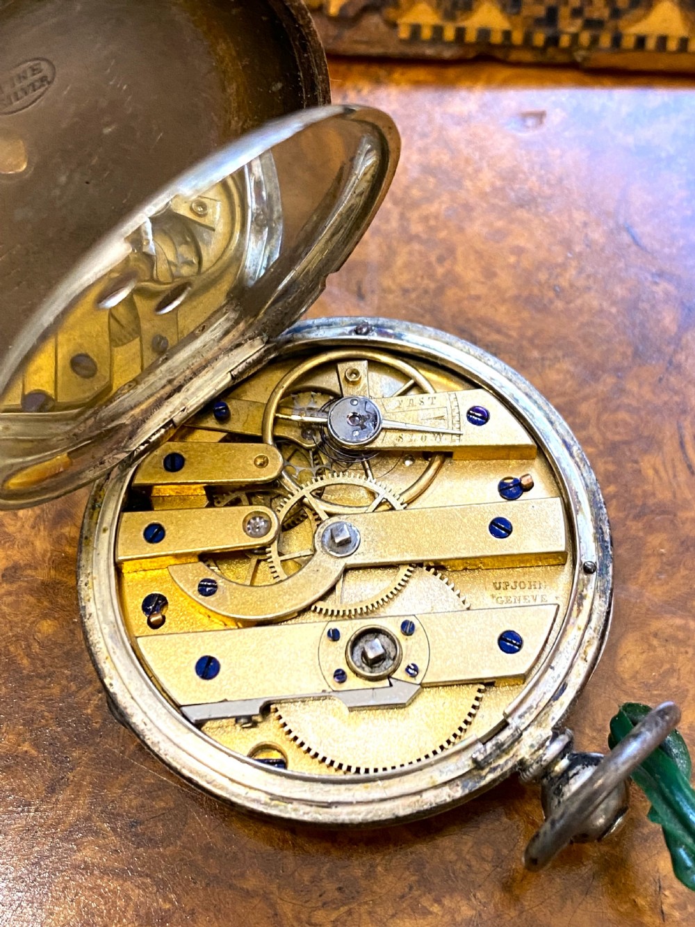 A square Victorian Tunbridge ware wooden pocket watch stand featuring geometric mosaic parquetry around a central pocket watch. View VIII