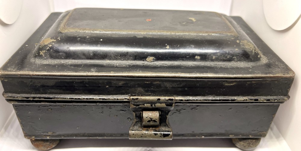 An open black lacquered toleware spice box displaying labelled inner compartments and a nutmeg grater fitted inside the lid. View II
