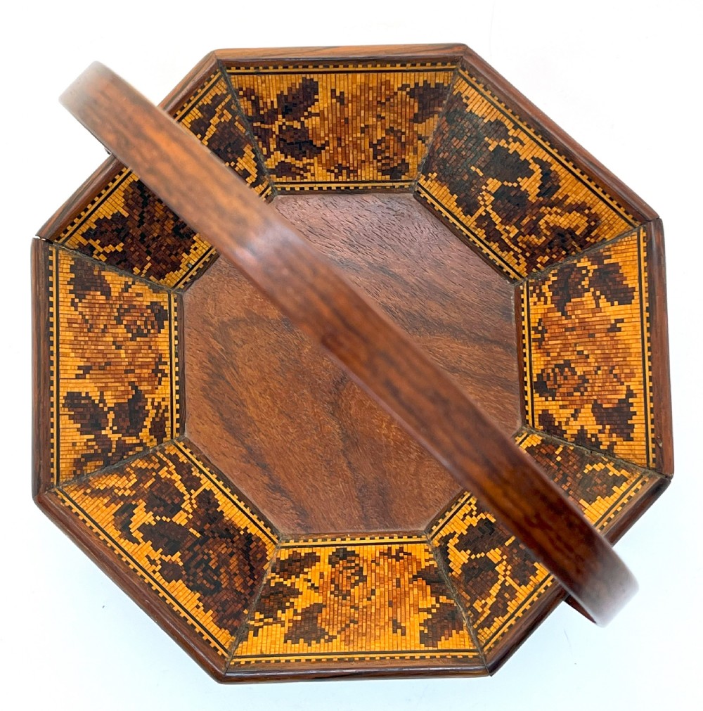 An antique Victorian octagonal rosewood basket with a high overhead handle and intricate micro-mosaic geometric floral wood inlay on the interior panels. View II