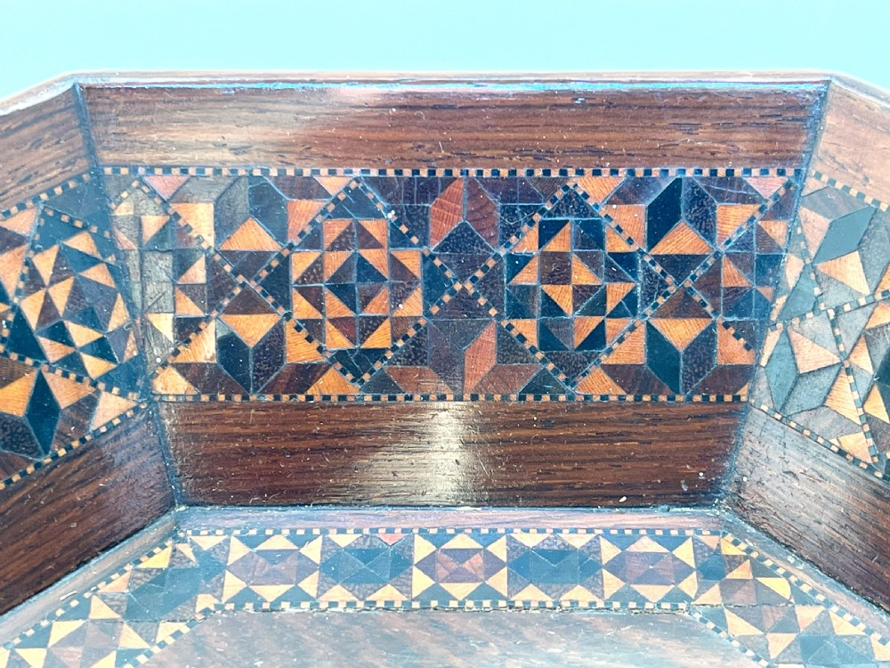 An octagonal Victorian Tunbridge ware wooden dish featuring geometric mosaic borders and a central yellow wooden panel with a black butterfly inlay. View V
