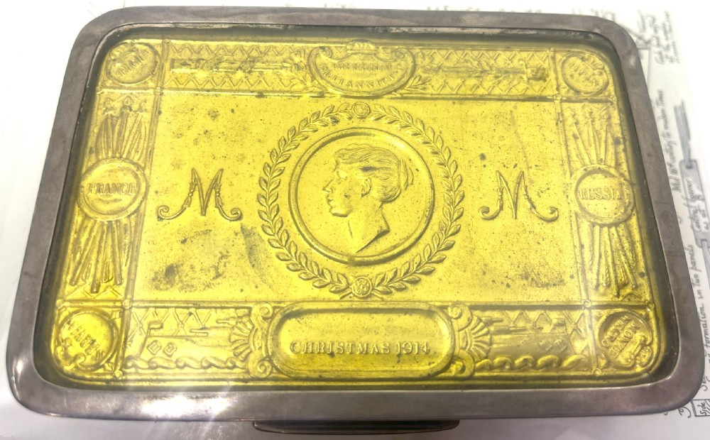 An embossed brass 1914 Princess Mary gift tin mounted inside a silver outer frame. View II