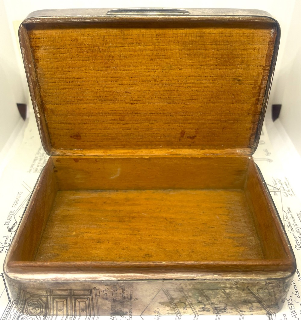An embossed brass 1914 Princess Mary gift tin mounted inside a silver outer frame. View VIII