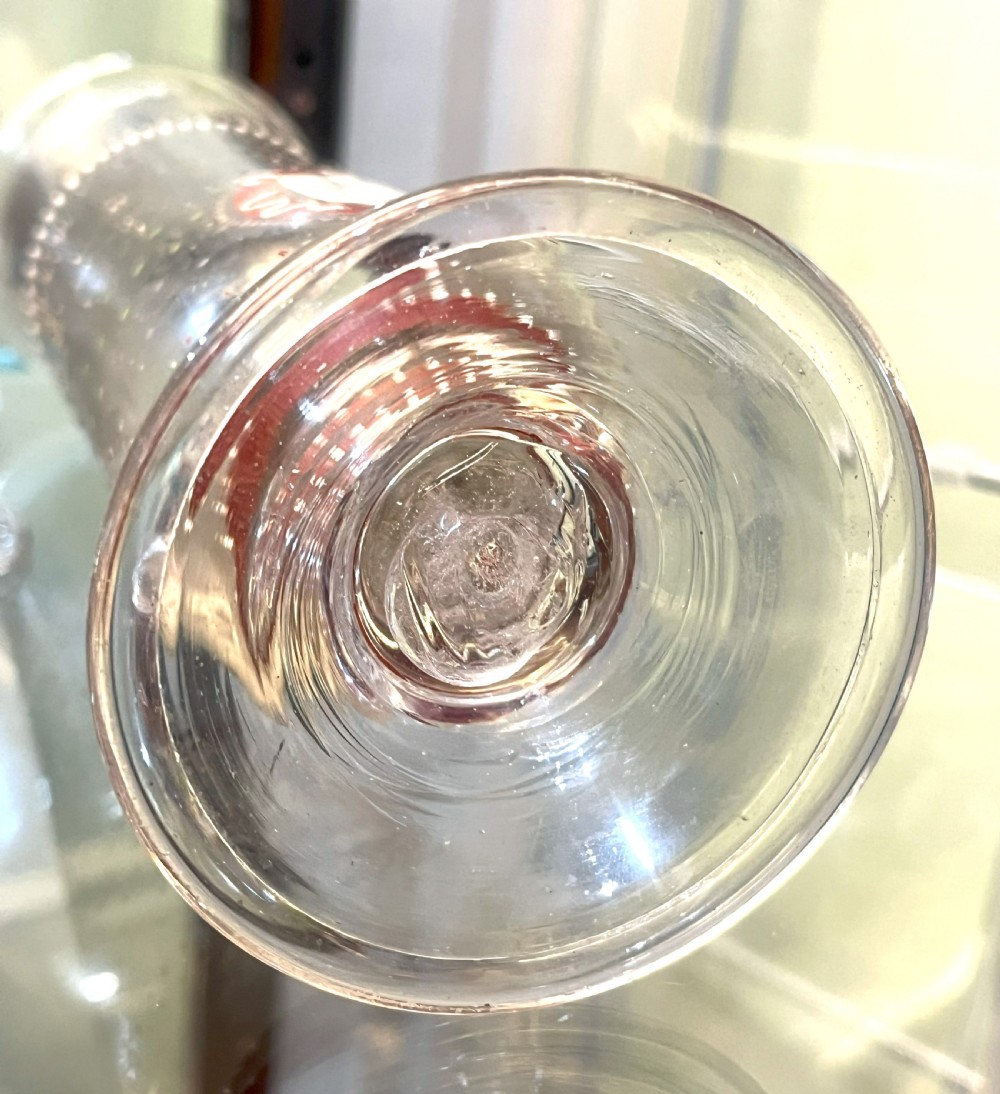 A pair of tall clear glass vases featuring hand-painted white and red enamel dot patterning and heraldic shield crests on stepped pedestal bases. View VI