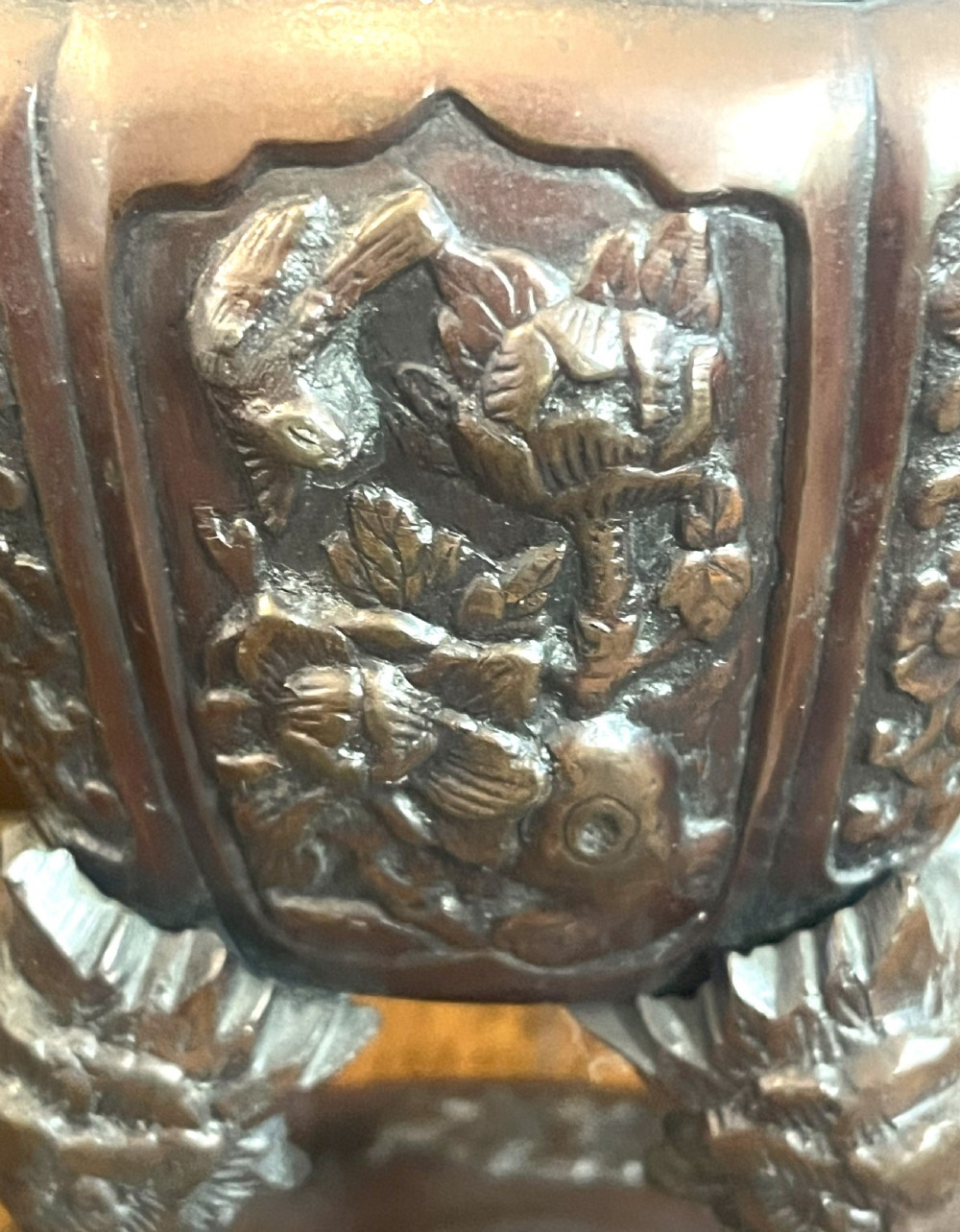 A cast dark bronze Japanese incense burner featuring a shishi guardian dog finial on the lid, floral relief panels, phoenix handles, and beast-head legs. View IV