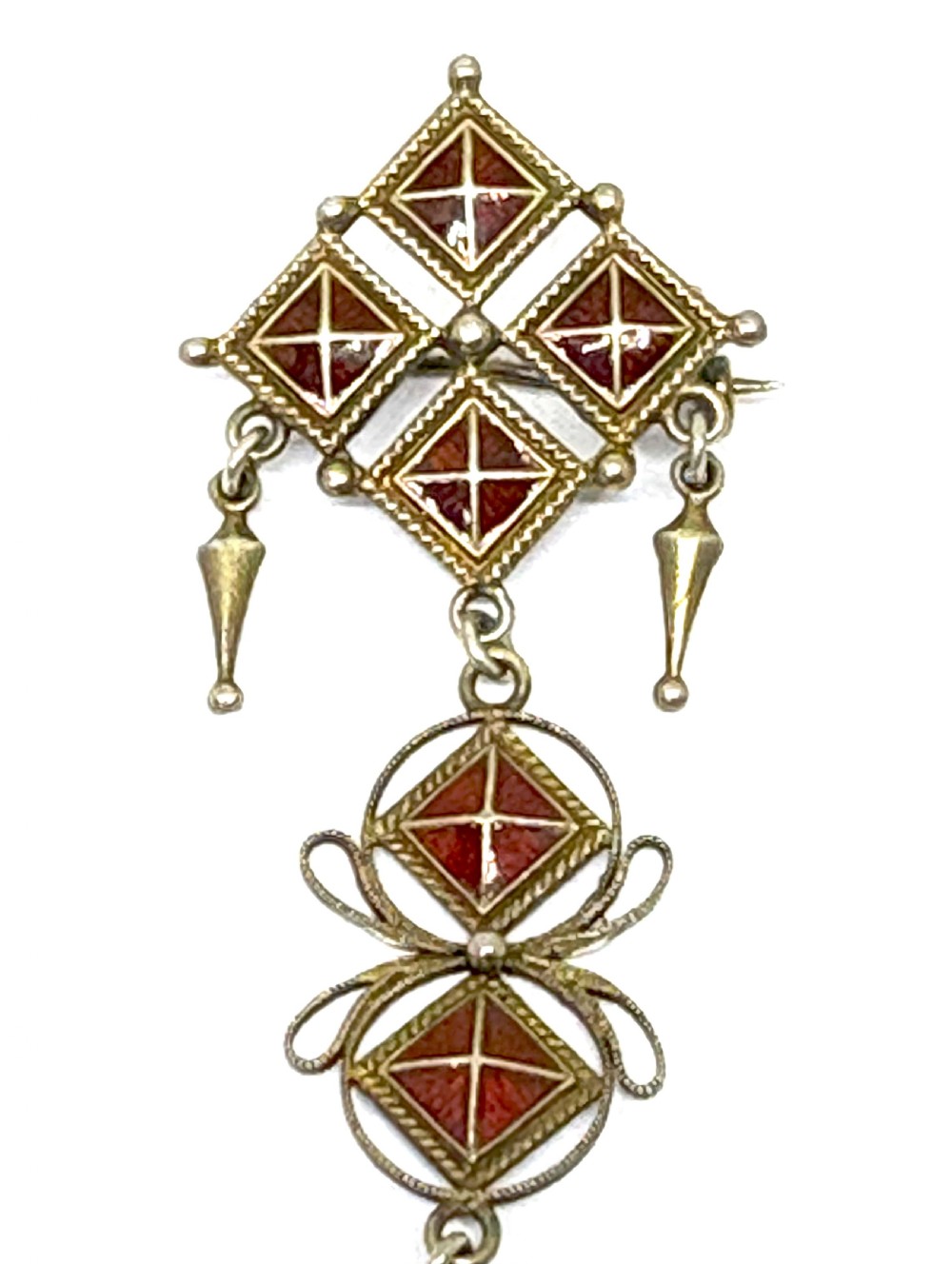 Norwegian silver gilt pendant brooch featuring diamond-shaped red guilloche enamel sections, filigree scrollwork, and suspended conical metal drops. View II
