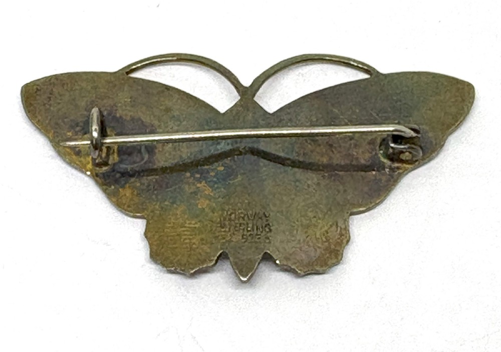 A Norwegian sterling silver and white guilloche enamel brooch crafted in the detailed form of a butterfly with a black body. View III