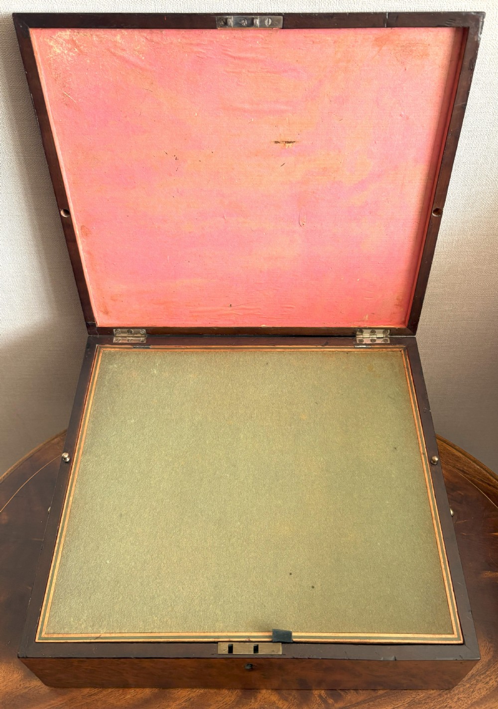 A rectangular burr yew wood box featuring a central oval medallion depicting cherubs with a lion, framed by geometric inlaid borders. View III