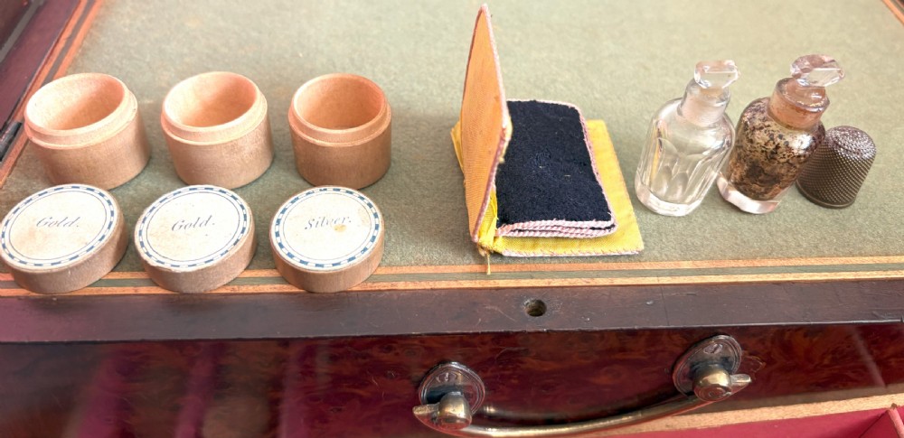 A rectangular burr yew wood box featuring a central oval medallion depicting cherubs with a lion, framed by geometric inlaid borders. View VIII