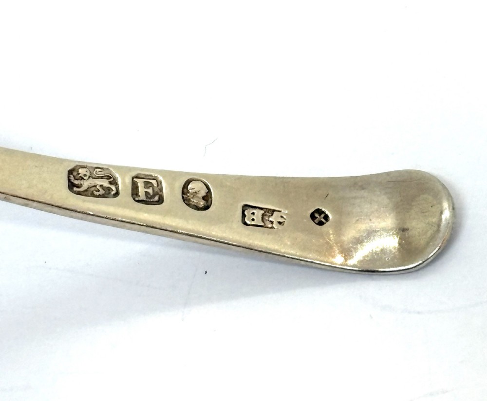 A Georgian sterling silver caddy spoon featuring a pierced oval bowl with engraved geometric detailing and a monogrammed handle. View III