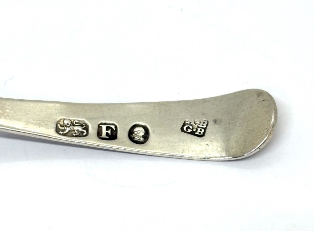 A sterling silver Georgian caddy spoon featuring a circular pierced bowl with bright-cut engraving and a monogrammed handle terminal. View III