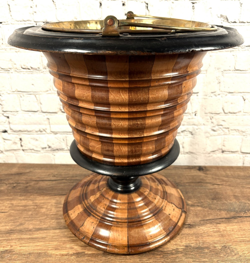 An antique early 19th-century Dutch teestoof featuring staved wood with alternating light and dark stripes, an ebonised rim, pedestal base, and a brass swing handle. View II