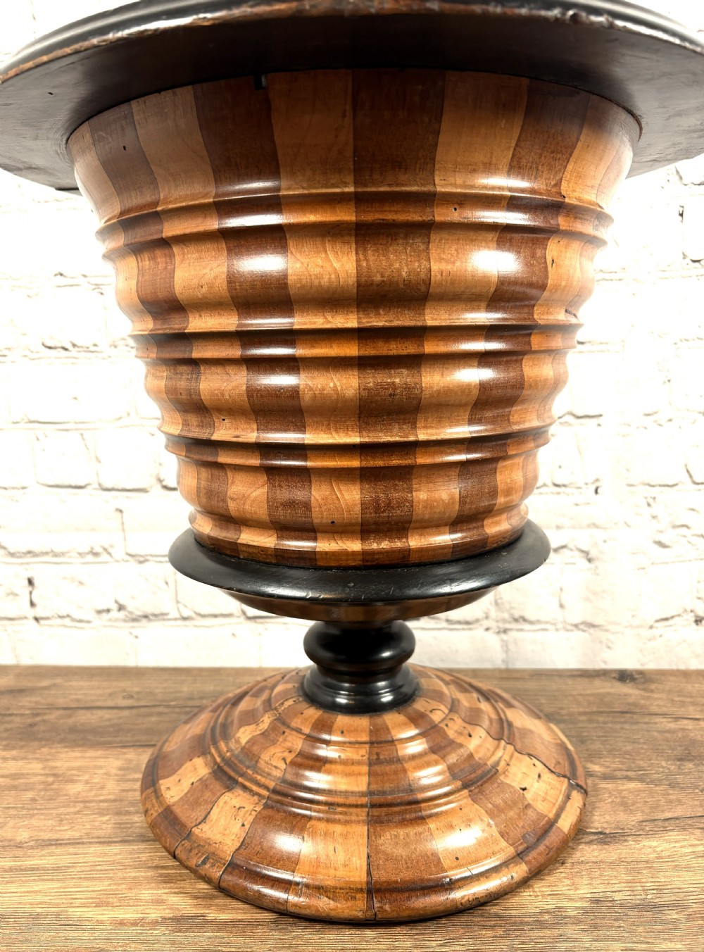 An antique early 19th-century Dutch teestoof featuring staved wood with alternating light and dark stripes, an ebonised rim, pedestal base, and a brass swing handle. View III