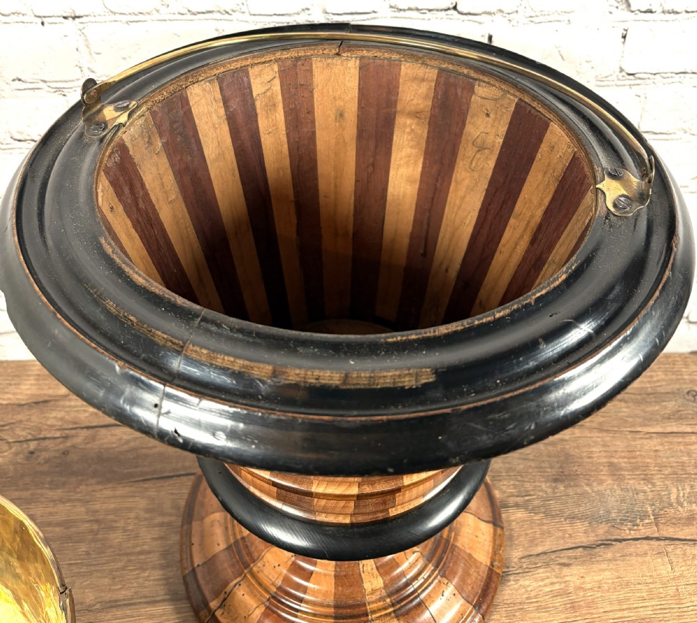 An antique early 19th-century Dutch teestoof featuring staved wood with alternating light and dark stripes, an ebonised rim, pedestal base, and a brass swing handle. View IV