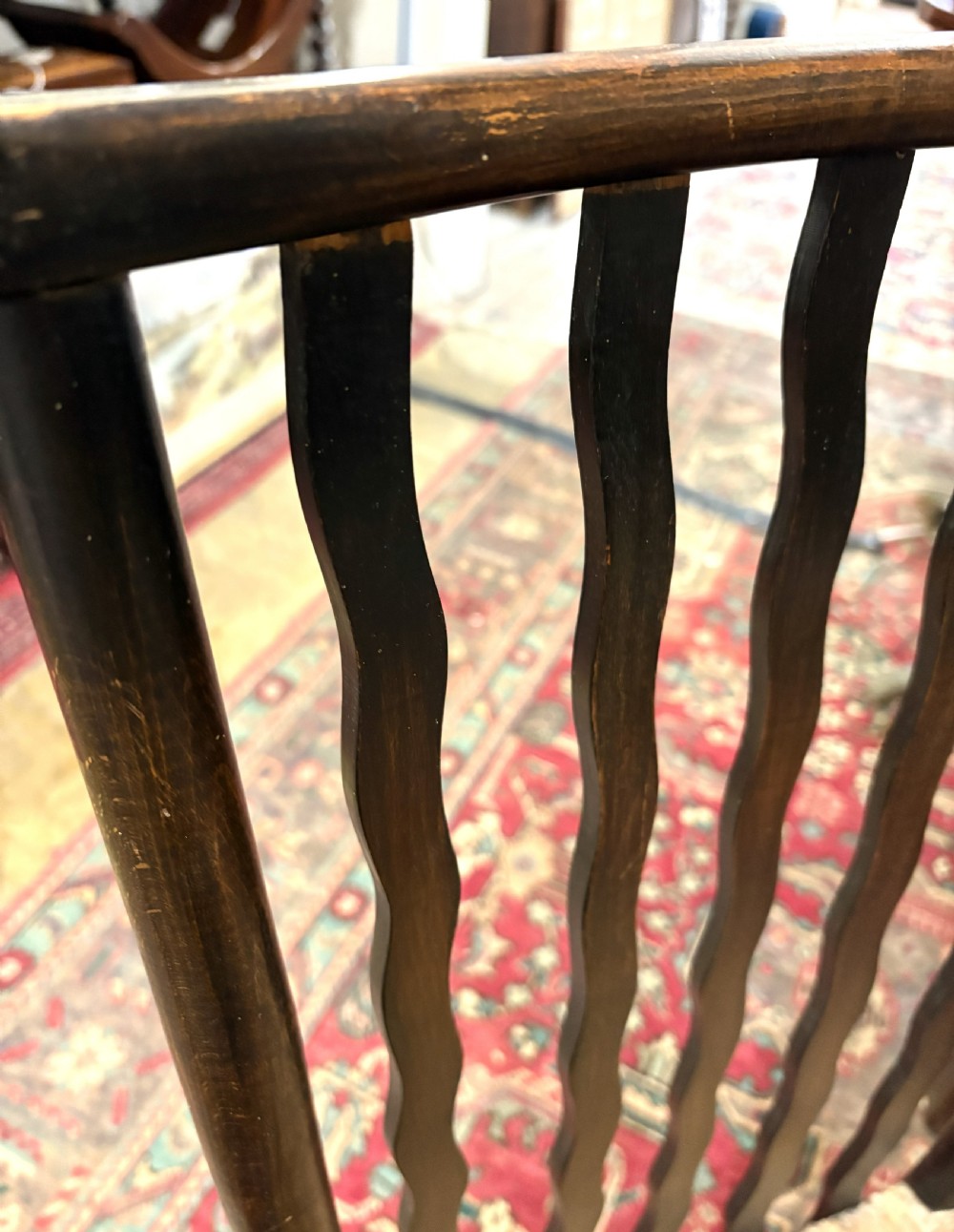 A pair of antique Arts and Crafts high-back dark wood armchairs featuring wavy back slats and woven natural rush seats. View IV
