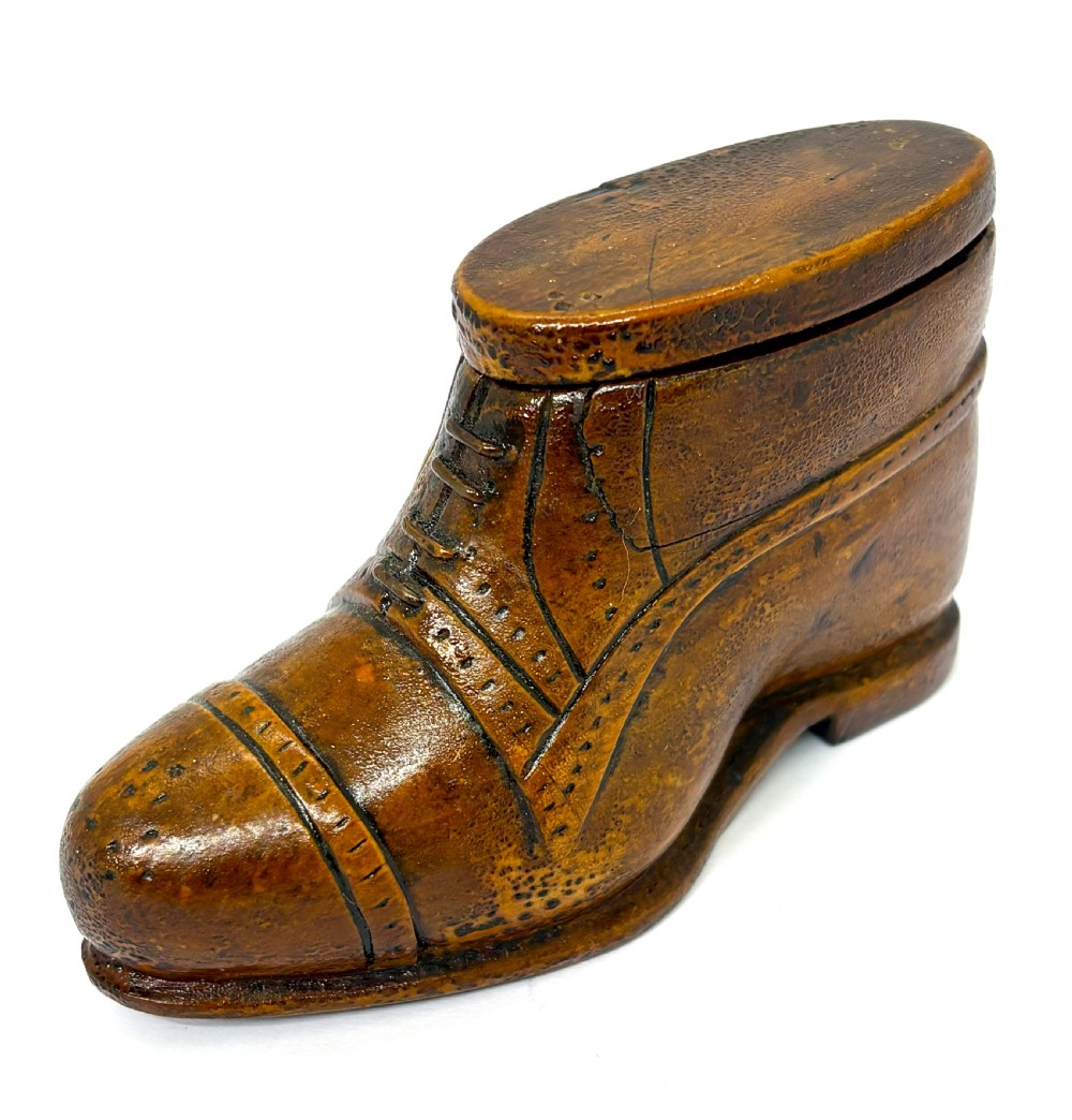 A hand-carved wooden treen snuff box shaped like a shoe with brogue details and a hinged top lid. View II