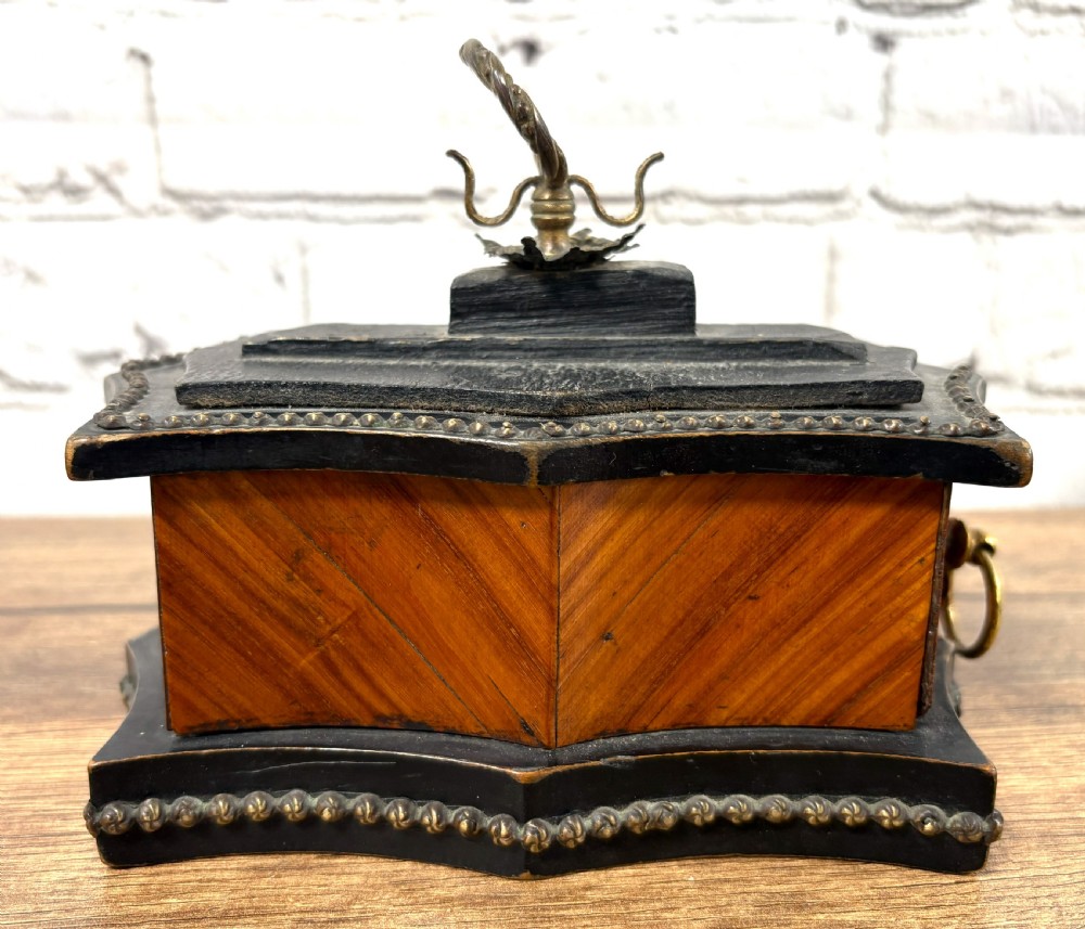A 19th-century French kingwood trinket box featuring a serpentine ebonised base, parquetry wood veneer, and brass handles with a partially open drawer. View II