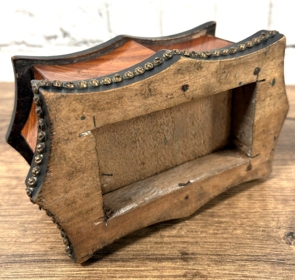 A 19th-century French kingwood trinket box featuring a serpentine ebonised base, parquetry wood veneer, and brass handles with a partially open drawer. View III