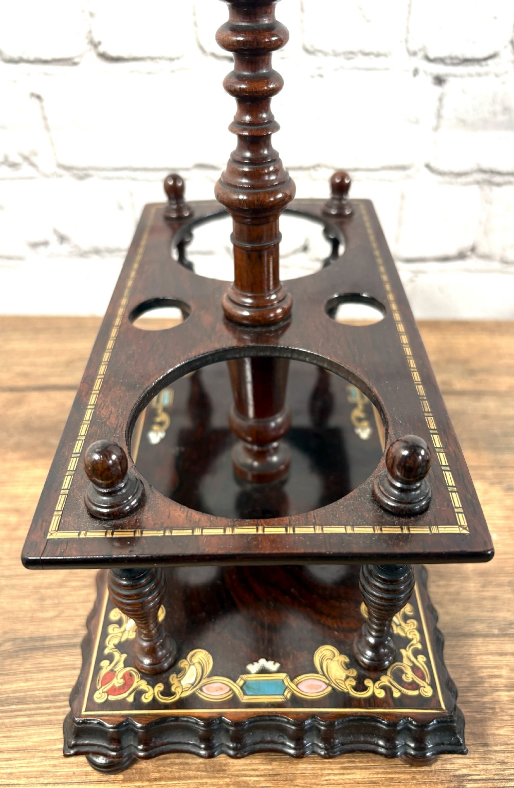 A Victorian dark rosewood decanter stand featuring decorative marquetry inlay, a turned central handle, and two cut glass decanters with faceted stoppers. View III