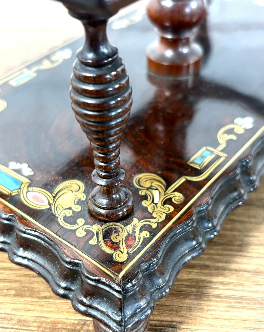 A Victorian dark rosewood decanter stand featuring decorative marquetry inlay, a turned central handle, and two cut glass decanters with faceted stoppers. View IV