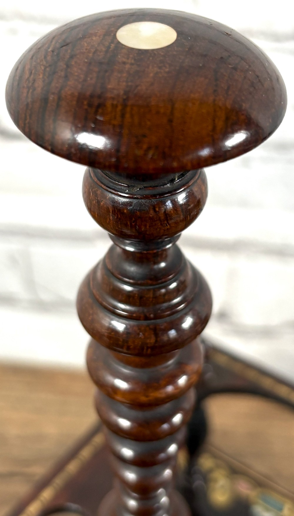 A Victorian dark rosewood decanter stand featuring decorative marquetry inlay, a turned central handle, and two cut glass decanters with faceted stoppers. View V