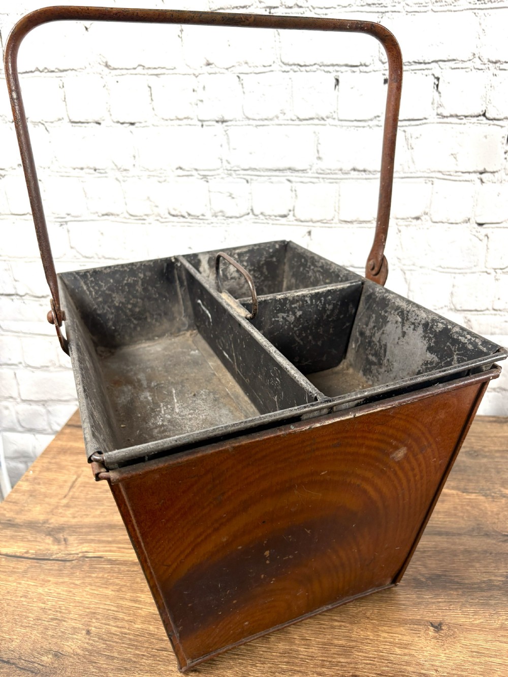 A Victorian painted sheet iron housemaid caddy featuring a faux-wood grain finish, internal compartments, and a tall metal carrying handle. View II