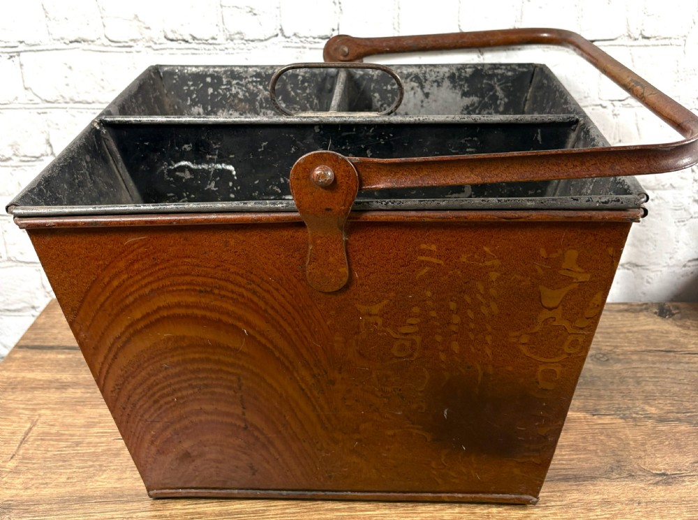 A Victorian painted sheet iron housemaid caddy featuring a faux-wood grain finish, internal compartments, and a tall metal carrying handle. View IV