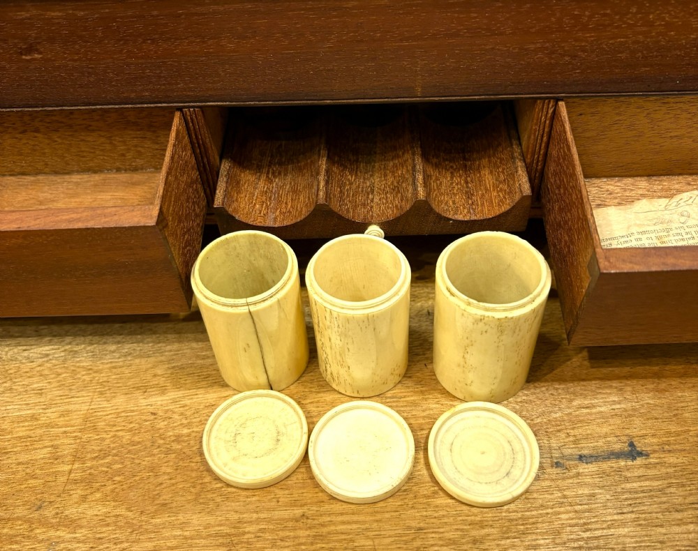 A rectangular mahogany writing slope box featuring flush brass corner brackets, brass strapping, and a central brass inlay. View VII