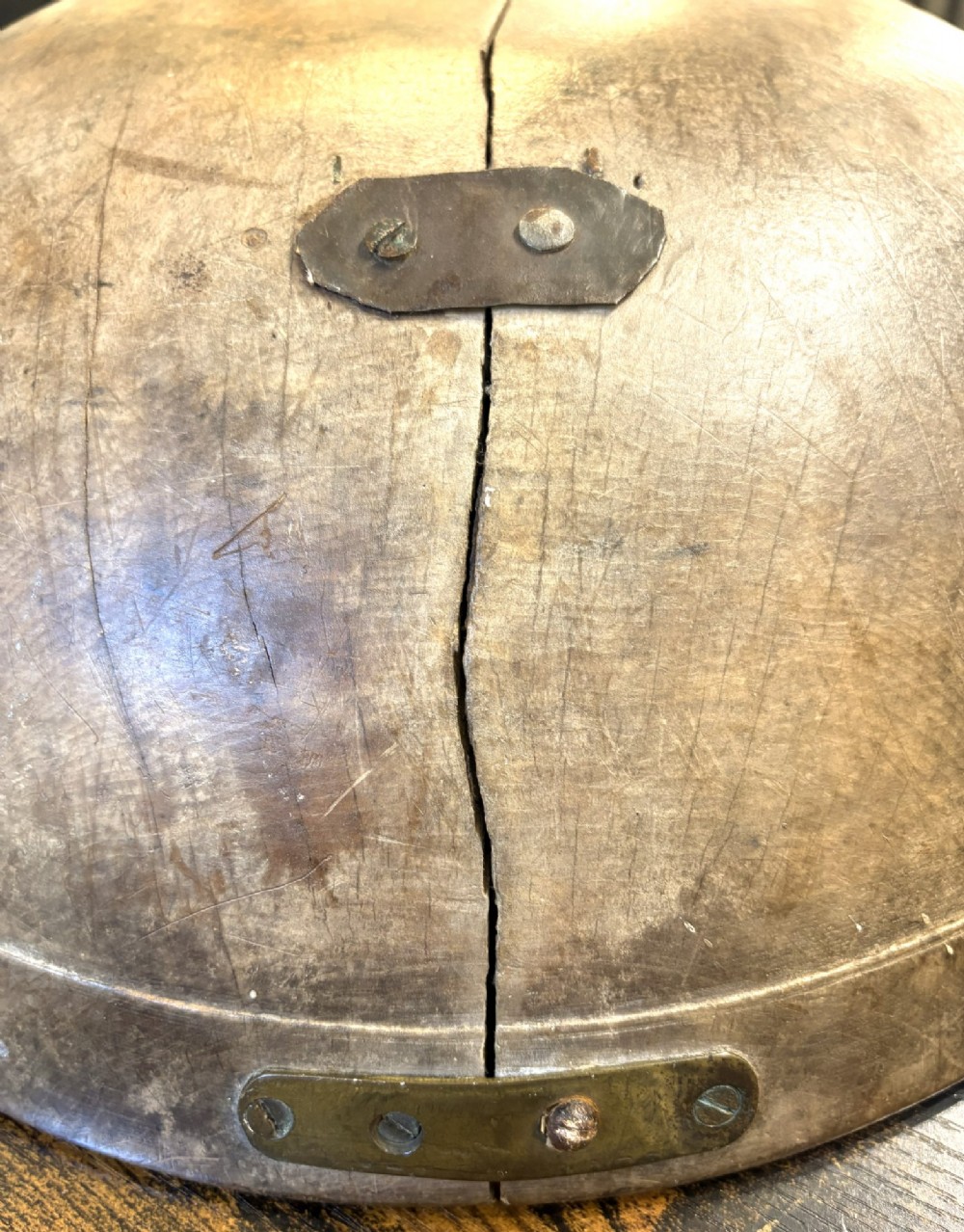 An eighteenth-century hand-turned sycamore wooden bowl displaying a weathered dark grey patina and an authentic historic timber split line. View VI