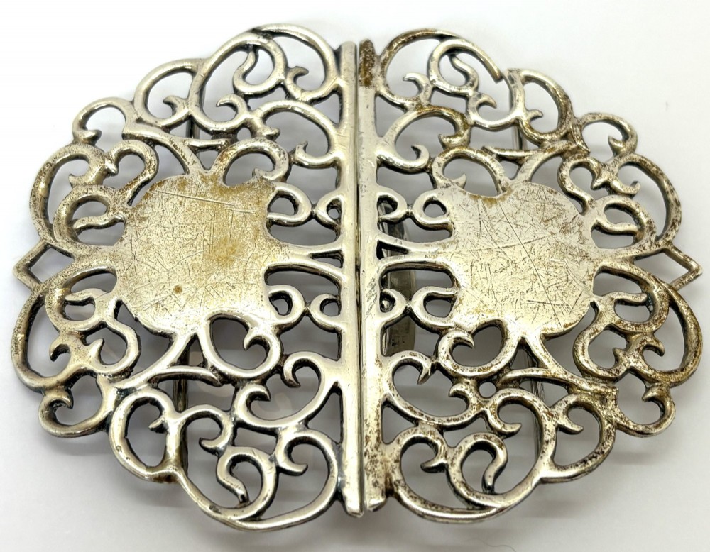 A two-piece pierced silver belt buckle with intricate scrollwork detailing, presented inside its original silk-lined presentation box. View II
