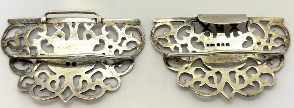 A two-piece pierced silver belt buckle with intricate scrollwork detailing, presented inside its original silk-lined presentation box. View IV